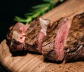 Sliced Ã¢â¬â¹Ã¢â¬â¹grilled beef steak tomahawk on a board, medium rare, close-up